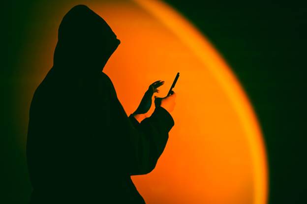 Woman on phone in the dark - Whistleblower